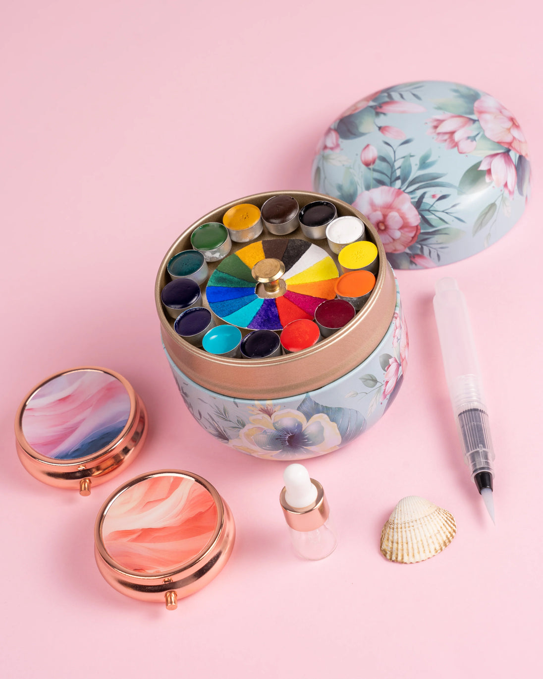 Lata redonda de acuarelas con pincel y gotero