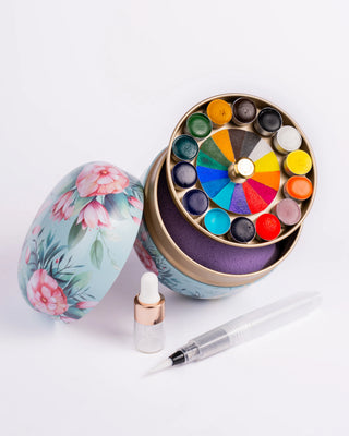 Lata floreada redonda redonda con acuarelas, esponja, pincel y gotero